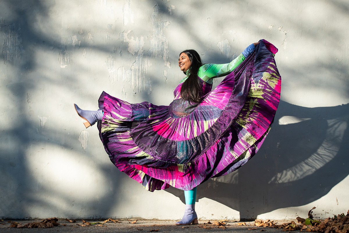 a lady wearing purple and multicolored dress